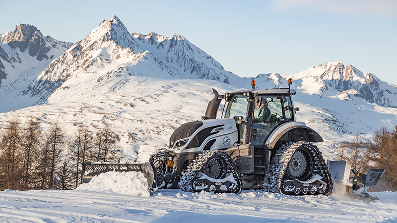 valtra unlimited customised tractor at an airport at snow work