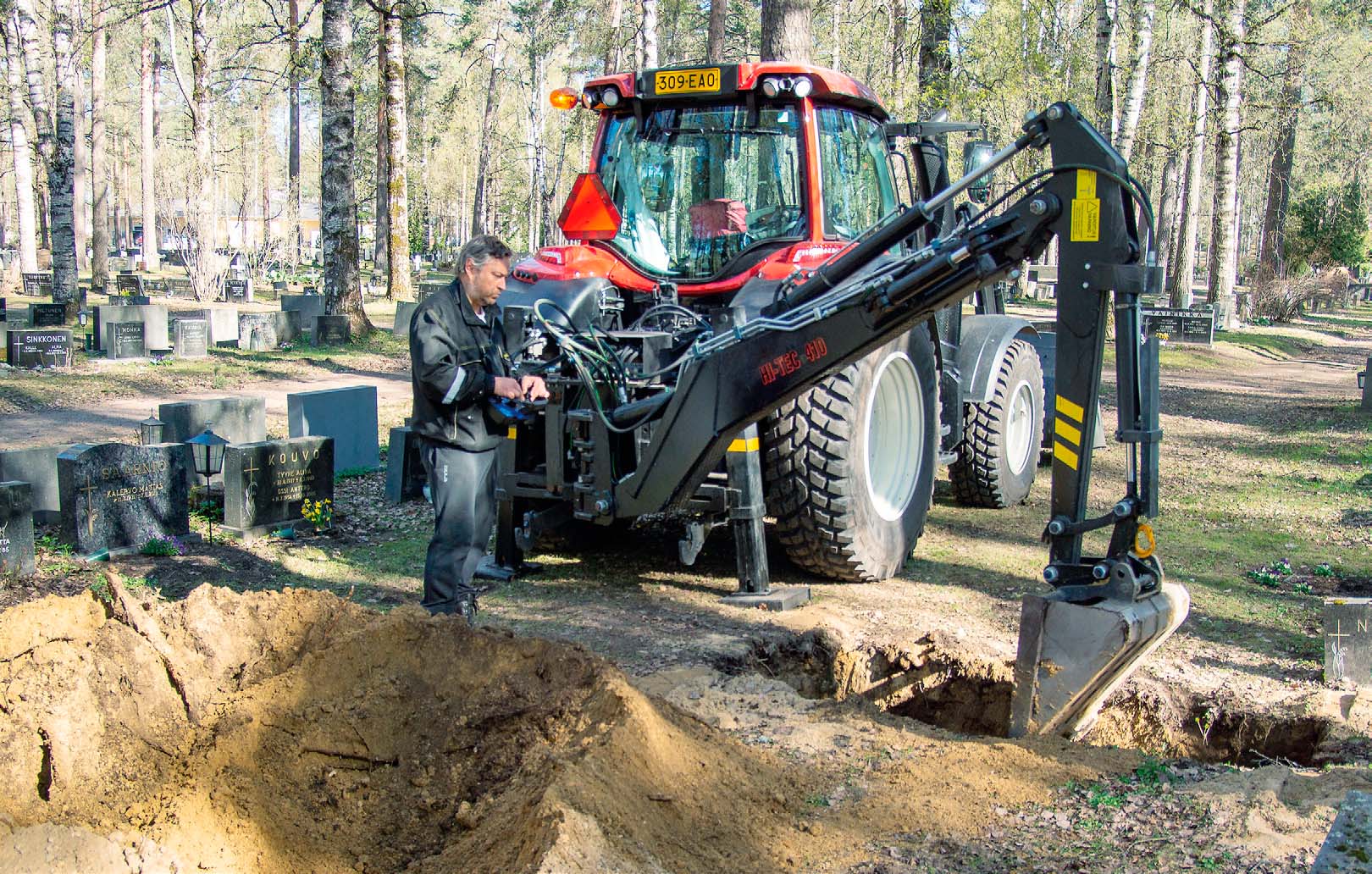 Valtra N104 digs burial plots by remote control